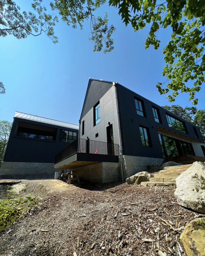 Exterior of Geothermal Project that features a radiant floor, a radiant ceiling, and hydronic fan coils.