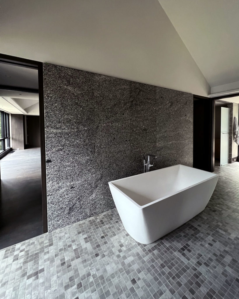 Bathroom in home that utilizes radiant ceiling, floor, and hydronic fan coils.