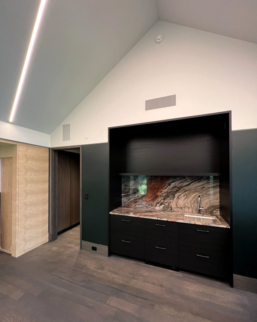 Granite sink in home that utilizes a radiant floor, ceiling, and hydronic fan coils.