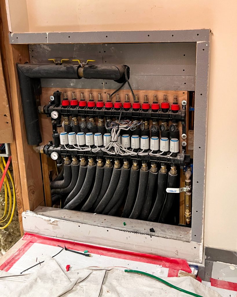 Hydronic manifold responsible for delivering radiant floor heating and cooling.